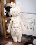 Karo the Softie Kangaroo Crochet Toy in front of framed greeting card 