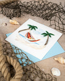 Quilled Beach Hammock Greeting Card next to netting, shells,  rope, on sand