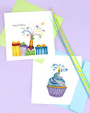 Quilled Birthday Champagne Greeting Card with green greeting card on purple background with quilling strips next to cupcake quilled greeting card