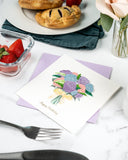 Quilled Hydrangea Bouquet Birthday Card on breakfast table with lilac envelope, flowers, hand pies, fruit, and silverware