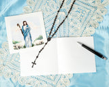 Quilled Jesus Greeting Card next to insert with cross necklace on top of lace and blue background