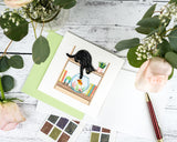 Quilled Mischievous Cat Greeting Card with light green envelope, stamps, florals, white wooden background, red pen