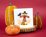 Quilled Scarecrow Greeting Card standing up with orange envelope surrounded by decorative pumpkin