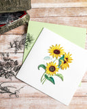 Quilled Wild Sunflowers Greeting Card with green envelope on wood background next to floral decals