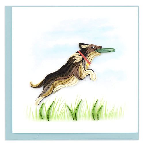 Blank quilled card of a dog jumping and catching a frisbee