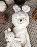 Karo the Softie Kangaroo Crochet Toy laying on blanket next to yarn and crochet hooks