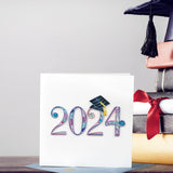 Quilled 2024 Grad Card standing next to books and graduation cap