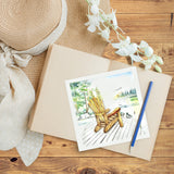 Quilled Adirondack Lake Greeting Card on top of book and sunhat on wooden table