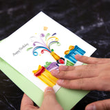 Quilled Birthday Champagne Greeting Card being held with green envelope