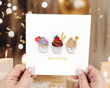 Quilled Birthday Cupcake Trio Greeting Card held in hands in front of confetti background