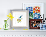  Quilled Bluebird & Babies Greeting Card in frame on mantel next to yellow flowers and framed artwork
