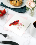 Quilled Cardinal & Cherry Blossom Greeting Card with pink envelope on kitchen table next to breakfast with strawberries and hand pies, florals, coffee, and utensils
