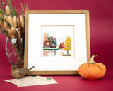 Quilled Cozy Autumn Cabin Greeting Card in golden frame next to fall decor with dark red background