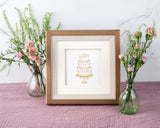 Quilled Elegant Wedding Cake Greeting Card in gold frame on purple table next to pink flowers in vases