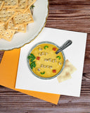 quilled get well soup greeting card with orange envelope next to plate of saltines on wooden background