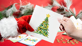 Quilled Gold Garland Christmas Tree Greeting Card being handed to person by santa claus with christmas decor in background