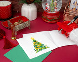 Quilled Gold Garland Christmas Tree Greeting Card open on table with card insert being written on by santa claus surrounded by christmas decor
