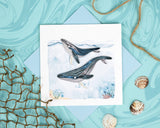 Quilled Humpback Whales Greeting Card with blue envelope on blue background with texture and netting, seashells, and rope