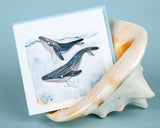 Quilled Humpback Whales Greeting Card inside of seashell on blue background