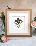 Quilled Iris Flower Greeting Card in golden frame surrounded by florals, on white wooden table with beige background