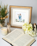 Quilled Jesus Greeting Card in golden frame in front of open book, flowers, candle, angel statues and dried flowers in vase