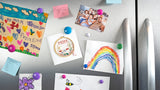 Quilled Mom Cross Stitch Greeting Card being placed on a fridge, surrounded by children drawings and family photos.