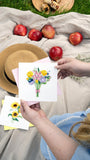 Quilled Spring Bouquet Greeting Card being held at picnic with sunhat, apples