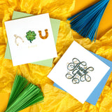 Quilled Thank You Greeting Card with blue envelope next to Quilled good luck greeting card on yellow background