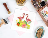 Quilled Tropical Flamingos Greeting Card with pink envelope next to wax seals, wax seal stamps, and stationary holder