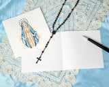 Quilled Vigin Mary Greeting Card with open insert with rosary on top and white lace on blue background