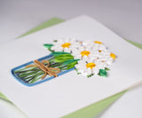 Close up detail of daisy quilled greeting card on green envelope