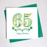 The number sixty five in different shades of green and reads Happy Birthday at the bottom.