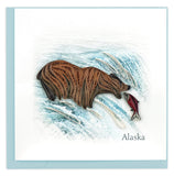 Greeting card featuring a quilled design of a brown grizzly bear catching a fish in the river