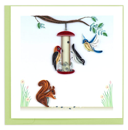 Blank greeting card featuring three quilled birds around a bird feeder hanging from a branch with a squirrel on the ground below