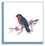 Greeting card featuring a quilled design of a bluebird sitting on a branch with pink flower blossoms