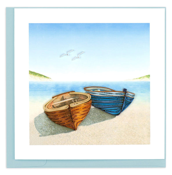 This award winning design features one orange and one blue canoe, laying on the beach in front of a scenic view. 