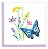 A quilled blue butterfly next to purple, yellow, and pink wildflowers