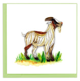 Blank greeting card of a quilled white goat with brown spots in patch of grass