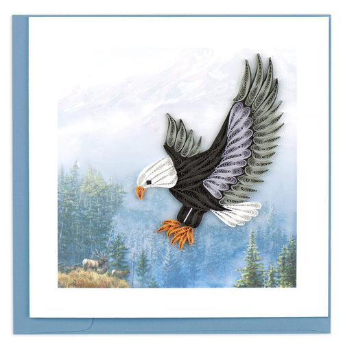 A brown and white bald eagle soaring above the mountains.