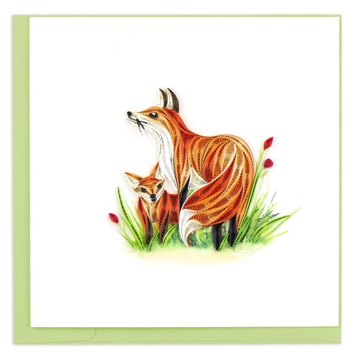 Blank greeting card of an orange fox and its cub  in tall green grass with red flower buds