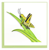 Blank Quilled Card of a green, yellow and black grasshopper on a blade of grass.
