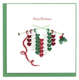 Quilled Christmas card featuring a red, green and white knit heart.