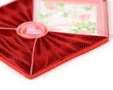 Detailed view of greeting card showing a quilled red envelope