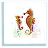 Two colorful seahorses in bright colors of orange, red and green. 