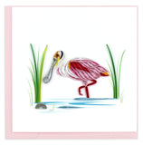 Blank greeting card of a quilled pink Spoonbill sending on one leg in the water surrounded by reeds