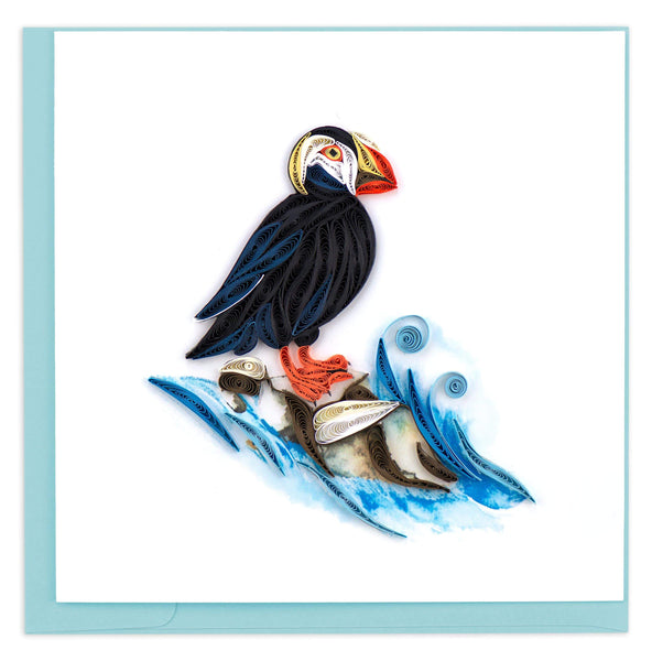 Blank handcrafted greeting card of a Tufted Puffin perched on rock being splashed by a wave